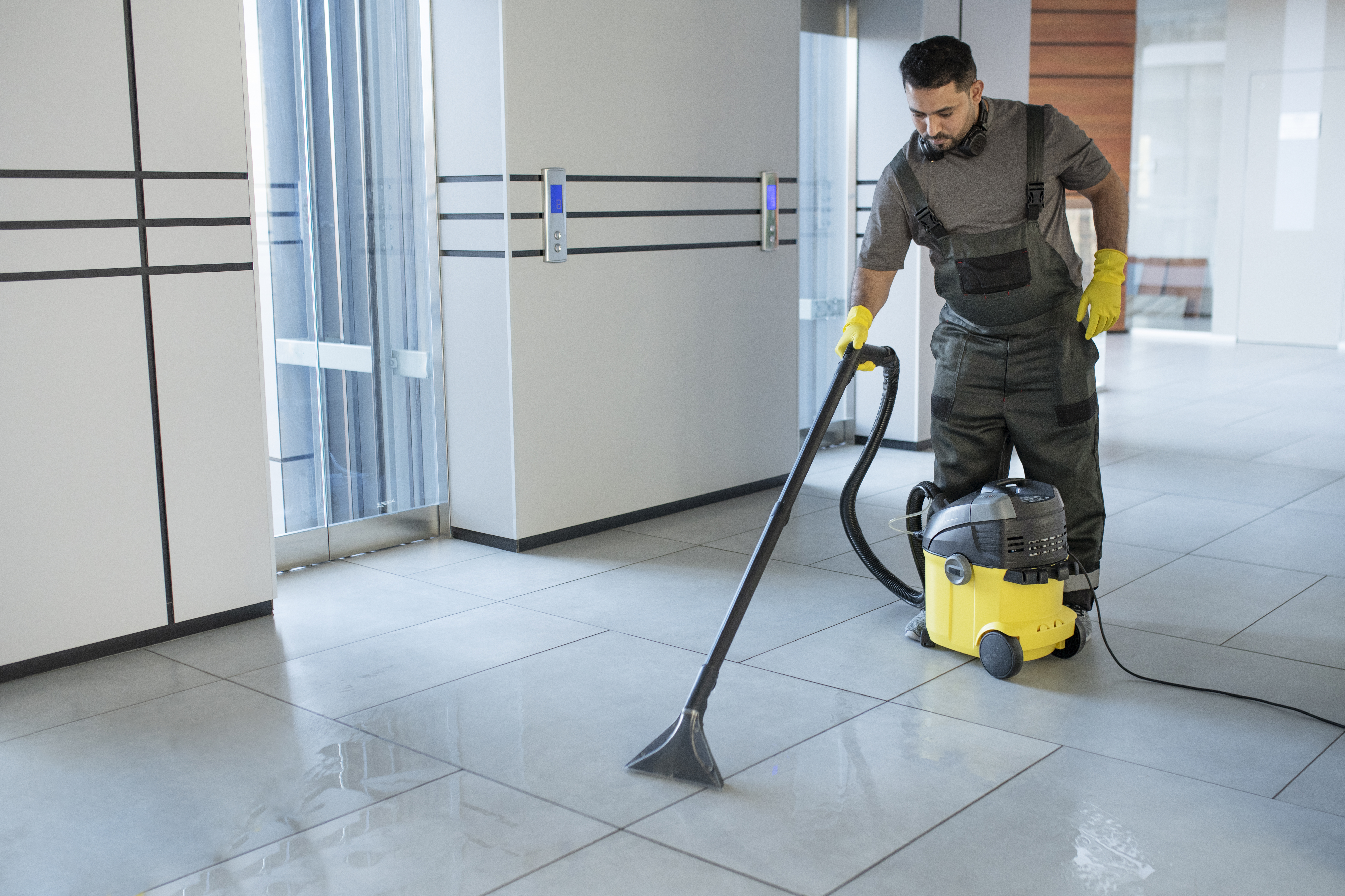 Cleaner vacuuming an office floor in Denver after hours