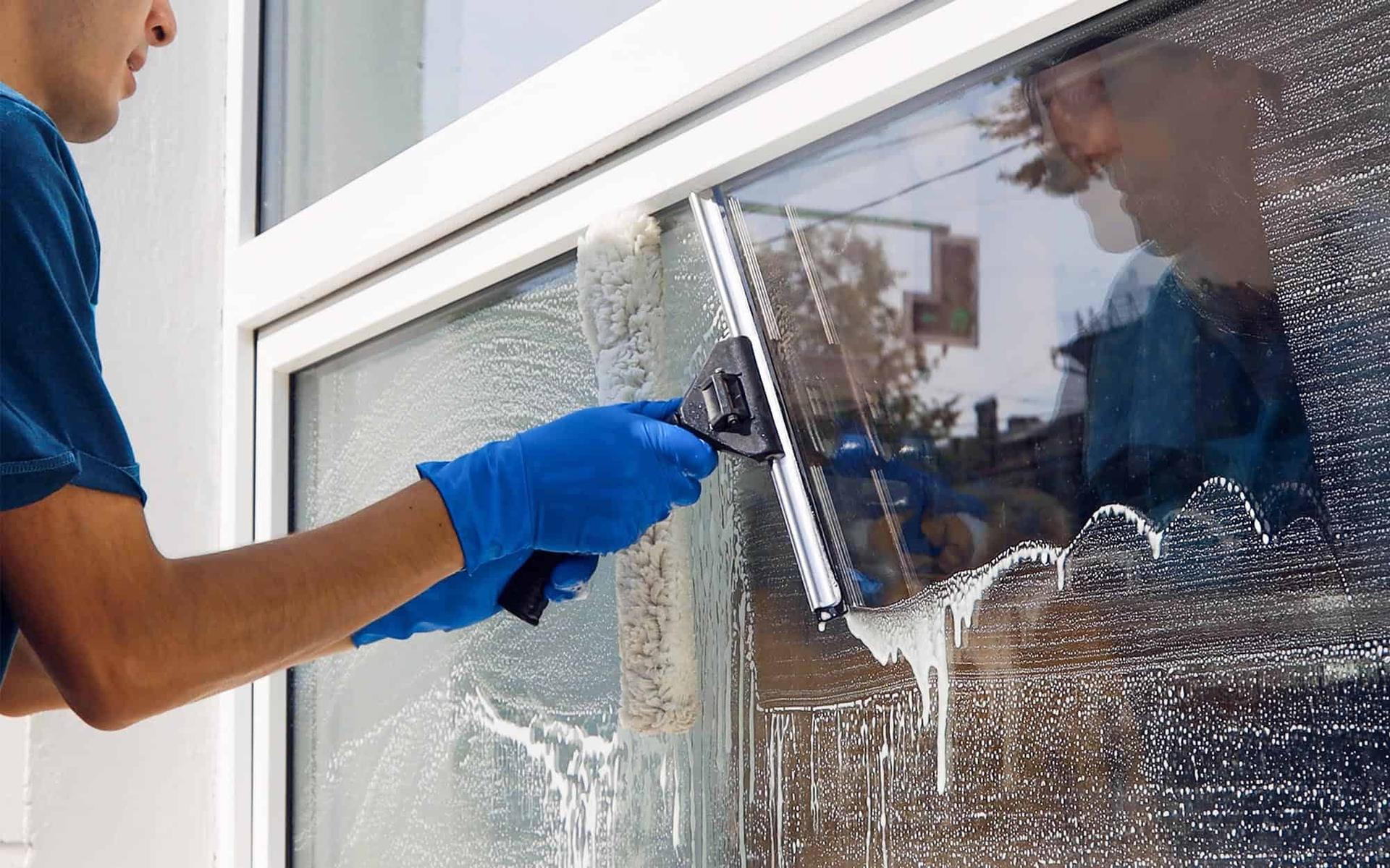Cleaning the exterior glass of a retail storefront in Denver