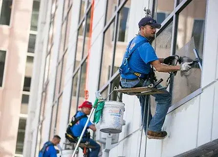 Commercial window cleaning service on a Denver office building